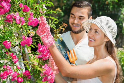 North London gardeners working in a lush garden